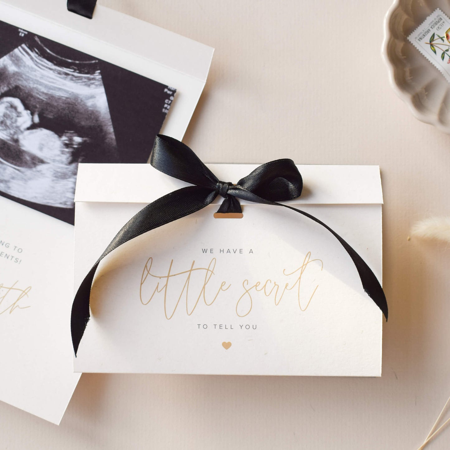 personalised pregnancy announcement card that reads 'we have a little secret to tell you'